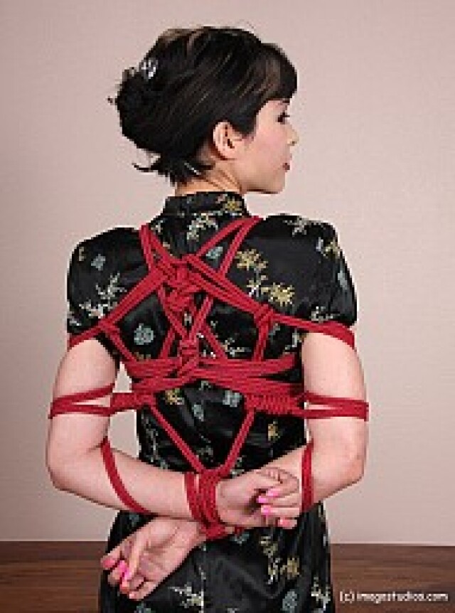 the girl has her hands tied behind her back