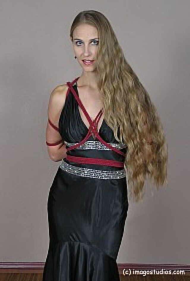 the girl has her hands tied behind her back