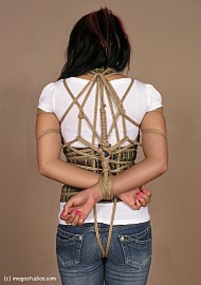 girl has her hands tied behind her back