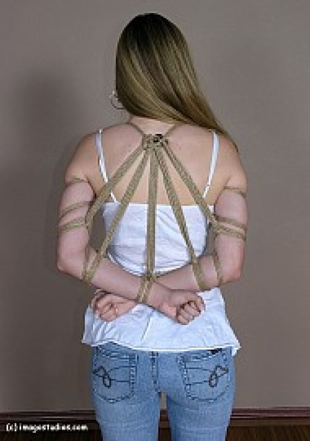 girl has her hands tied behind her back